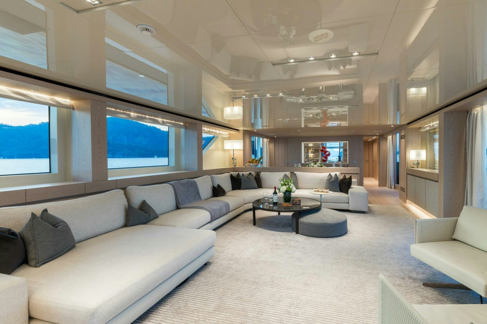 a large living room with white furniture aboard GLORY Yacht for Sale
