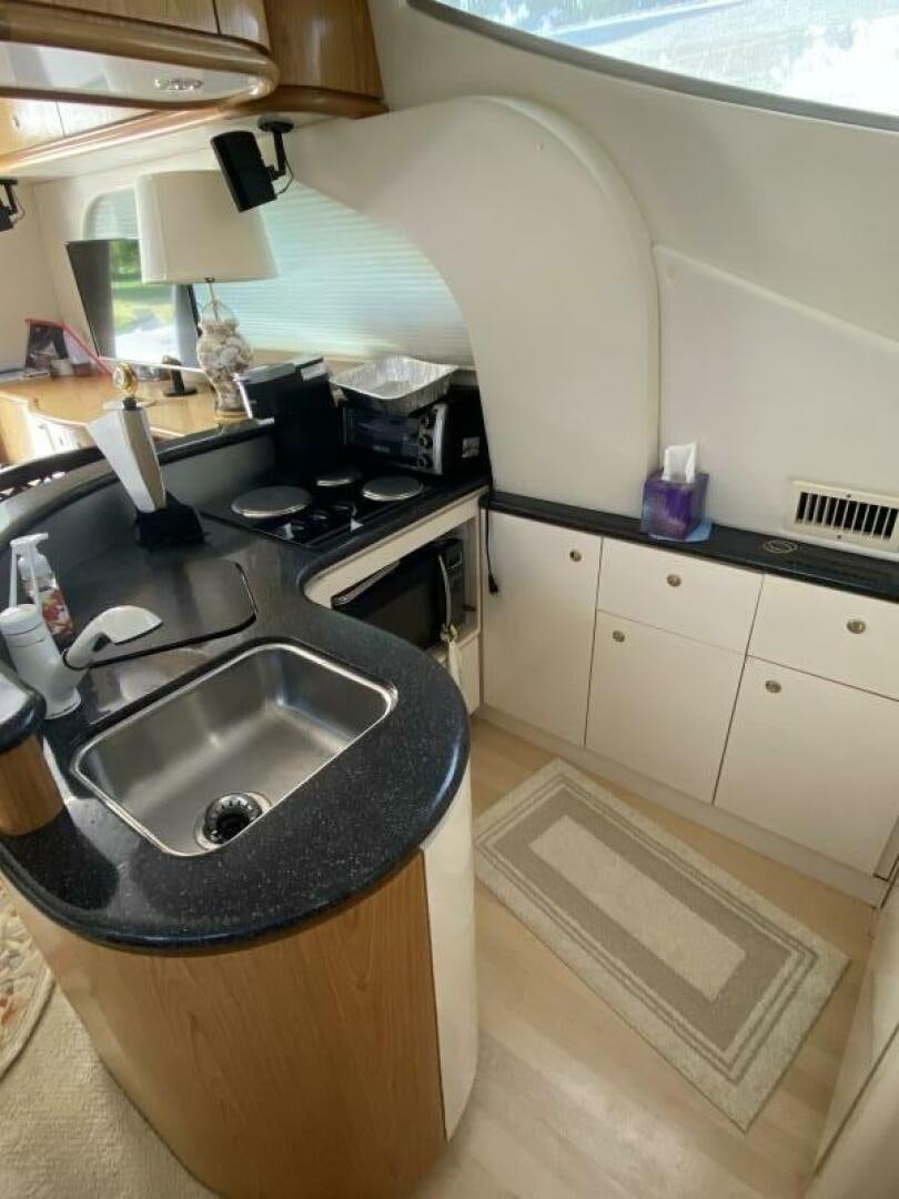 a kitchen with a sink and a stove aboard BIGG FIGG II Yacht for Sale