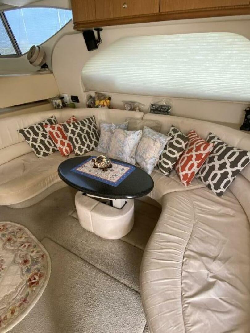 a living room with a white couch aboard BIGG FIGG II Yacht for Sale