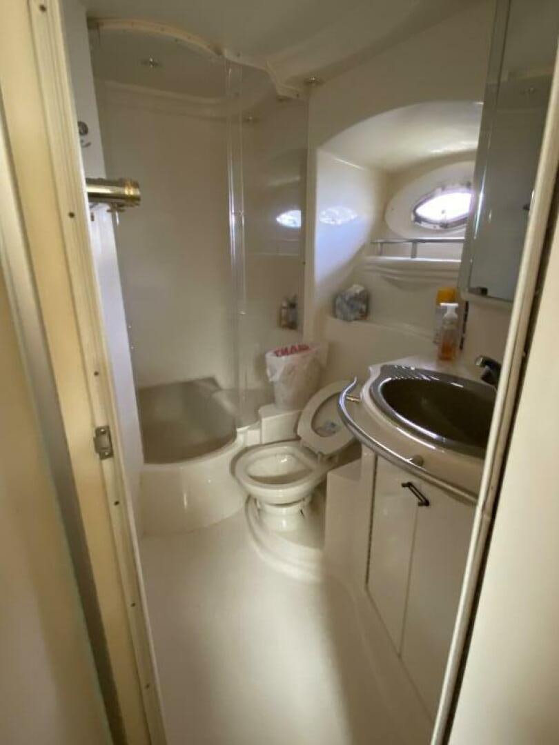 a bathroom with a sink toilet and a mirror aboard BIGG FIGG II Yacht for Sale