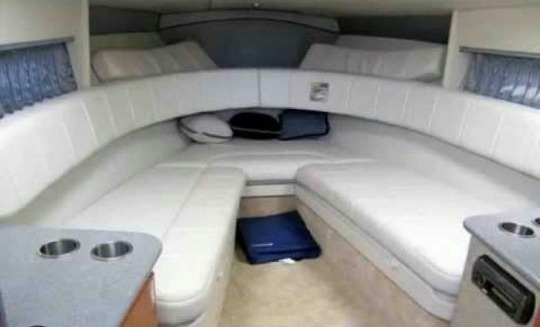 a bed with a white mattress and a black object on top aboard SERENITY NOW Yacht for Sale