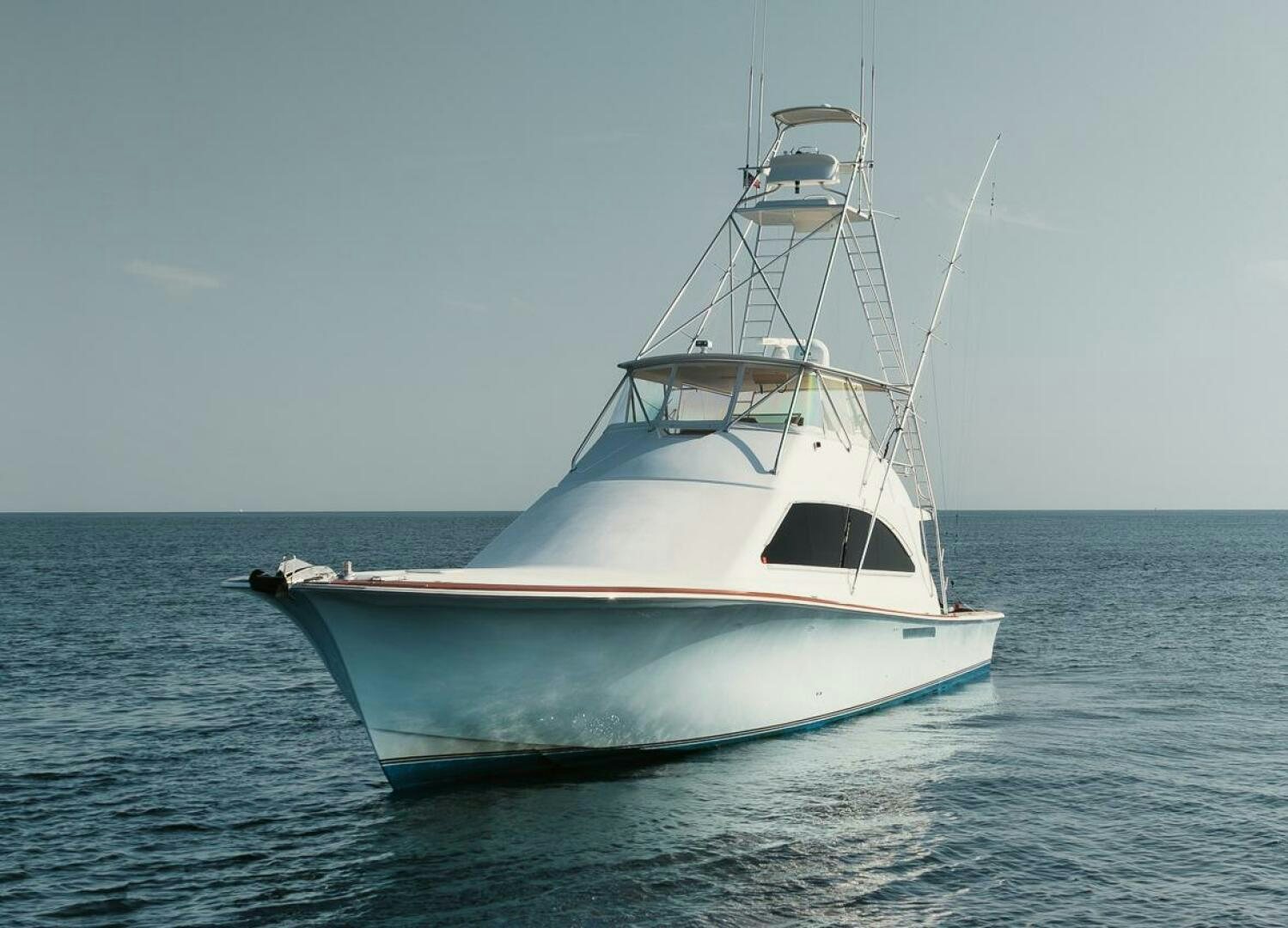 a white boat in the water aboard UNCONQUERED Yacht for Sale