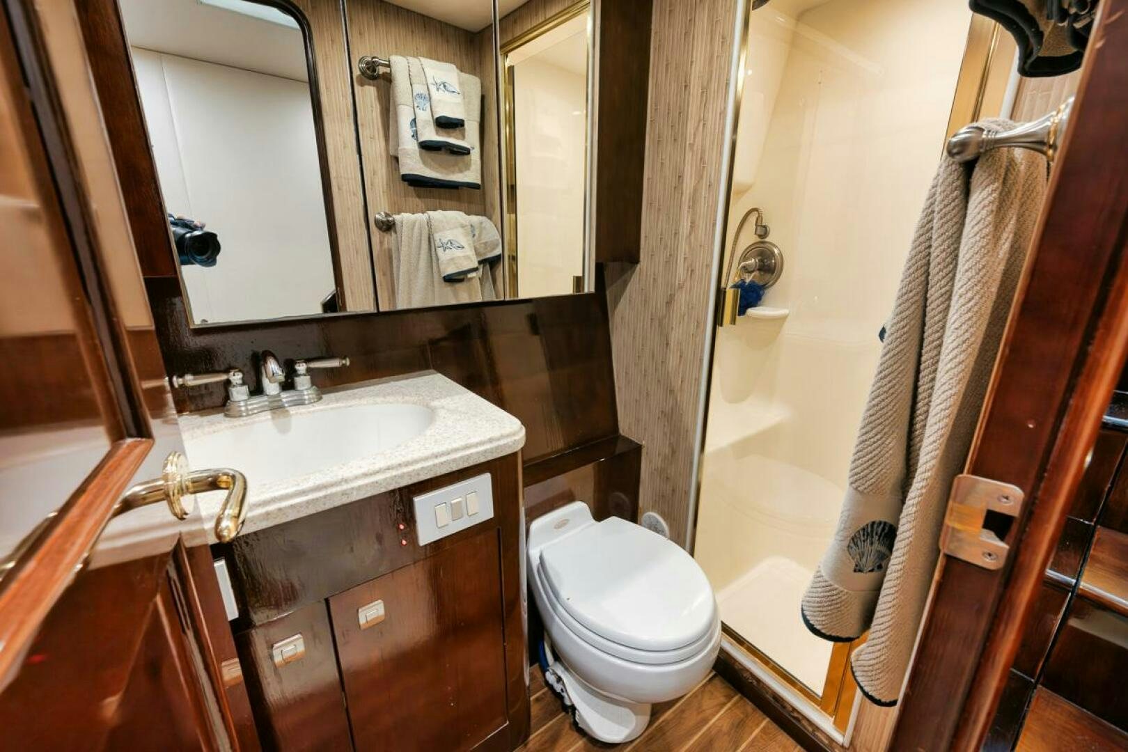 a bathroom with a sink toilet and a mirror aboard UNCONQUERED Yacht for Sale