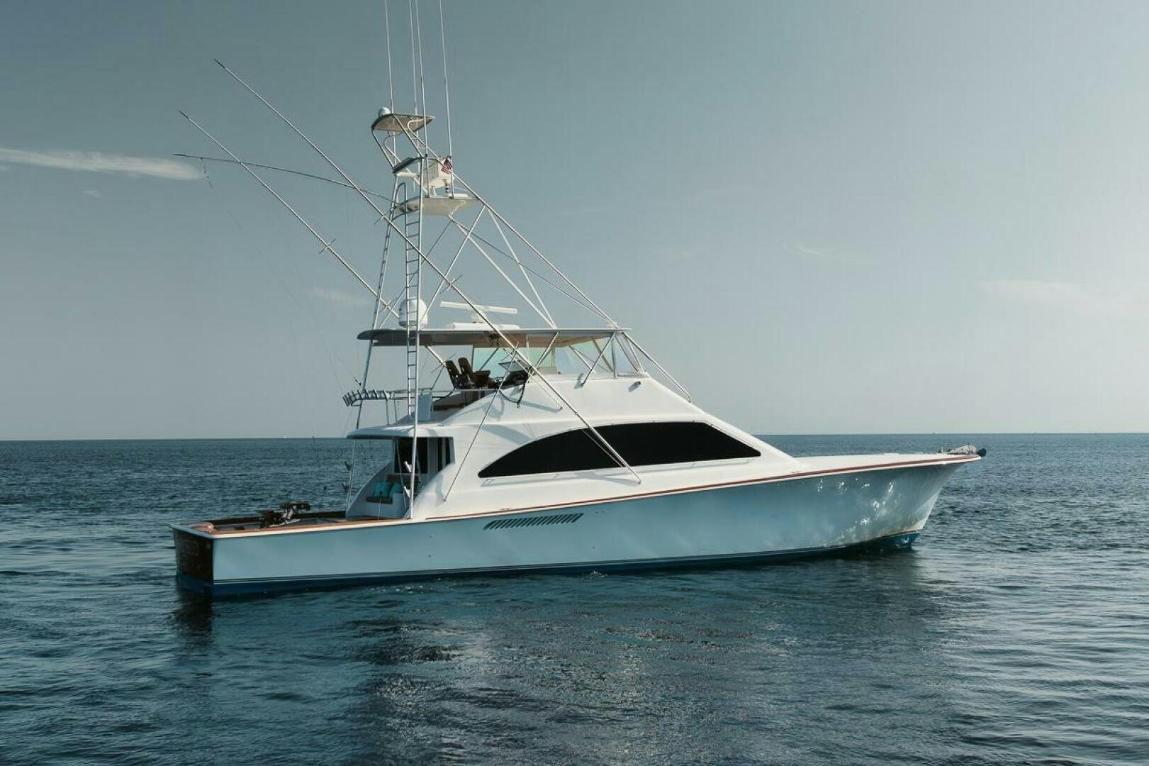 a white yacht in the water aboard UNCONQUERED Yacht for Sale
