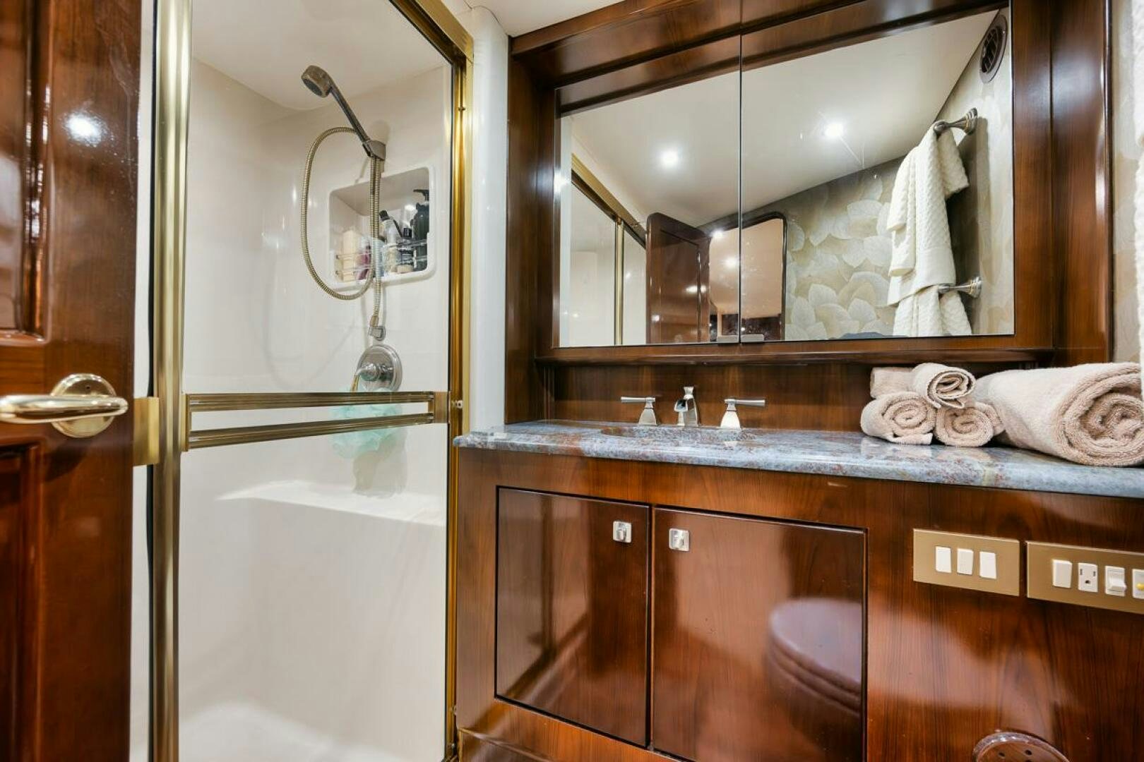 a bathroom with a sink and a mirror aboard UNCONQUERED Yacht for Sale