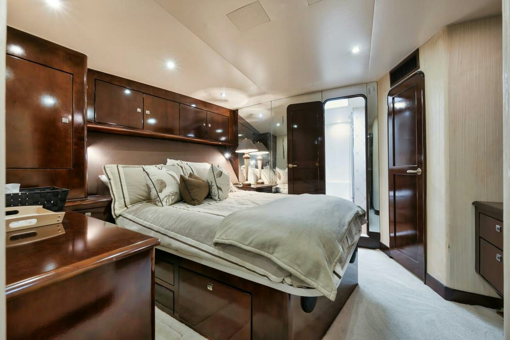 a bedroom with a bed and a desk aboard UNCONQUERED Yacht for Sale