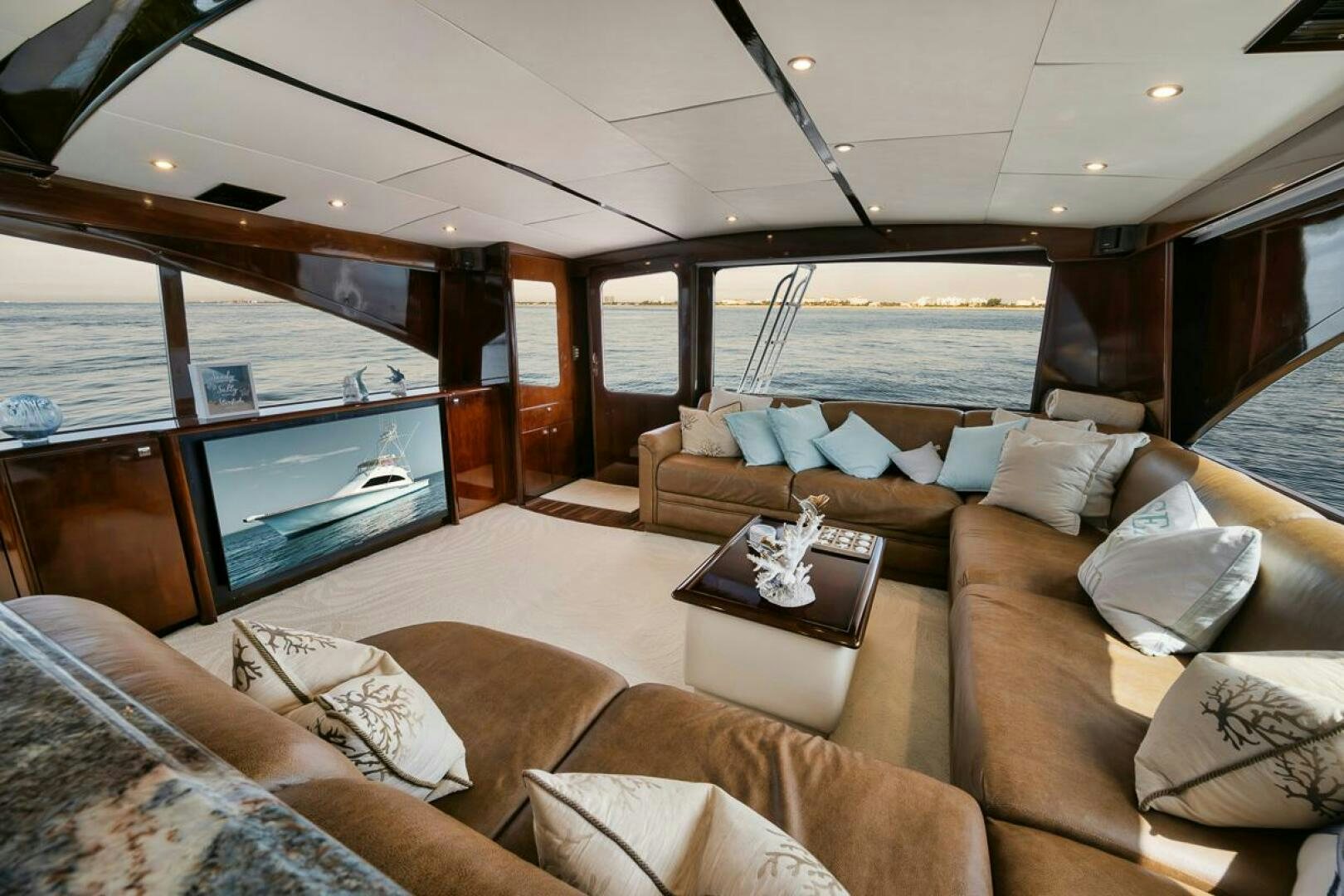 a living room with a large glass window aboard UNCONQUERED Yacht for Sale
