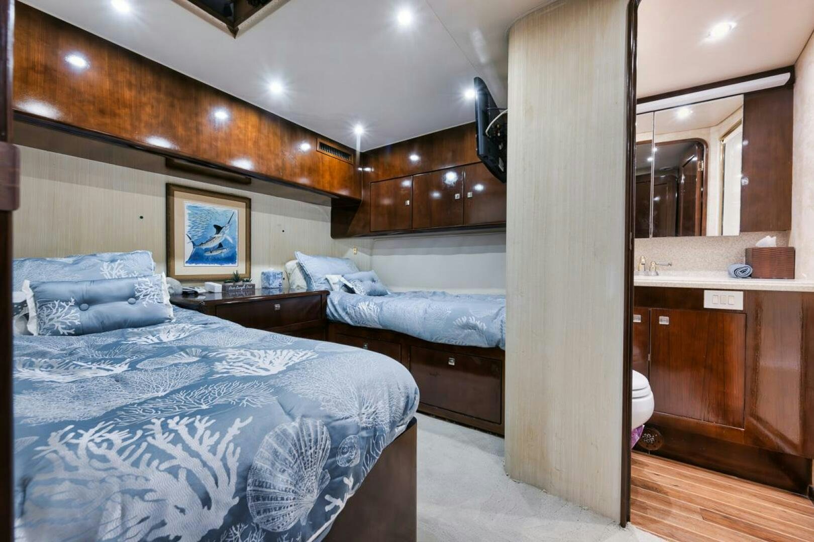 a room with a bed and a desk aboard UNCONQUERED Yacht for Sale