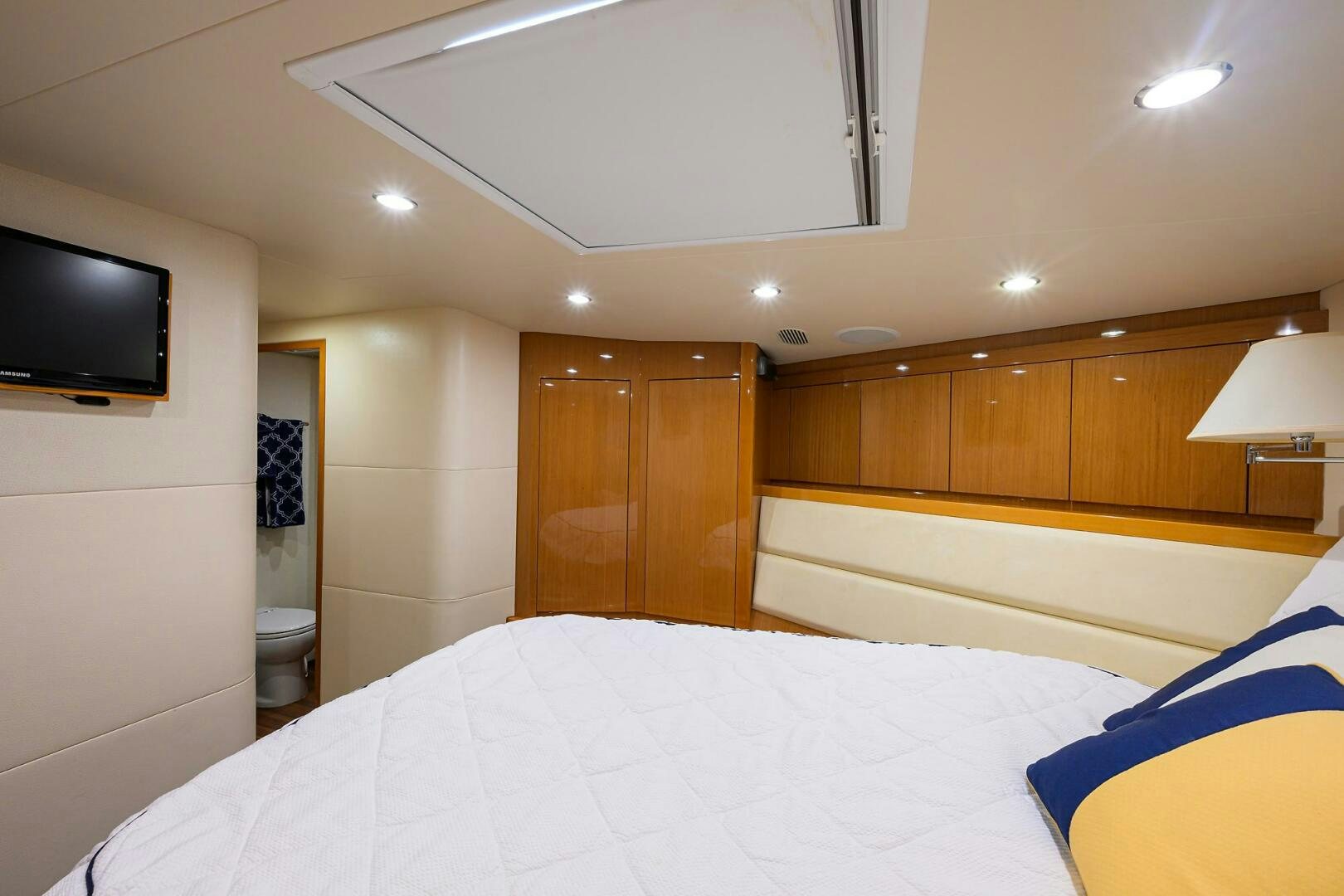 a hotel room with a bed and a tv aboard GOIN DEEP Yacht for Sale