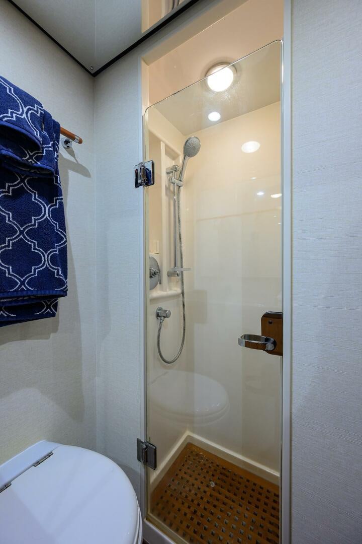 a bathroom with a shower and a toilet aboard GOIN DEEP Yacht for Sale