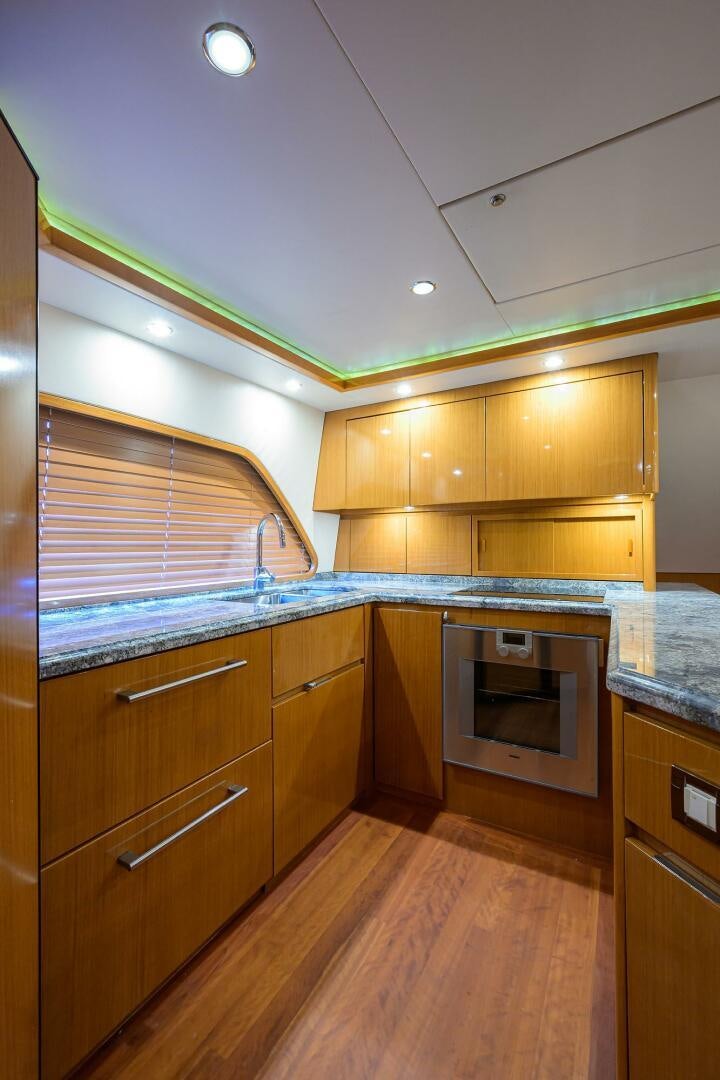 a kitchen with wooden cabinets aboard GOIN DEEP Yacht for Sale