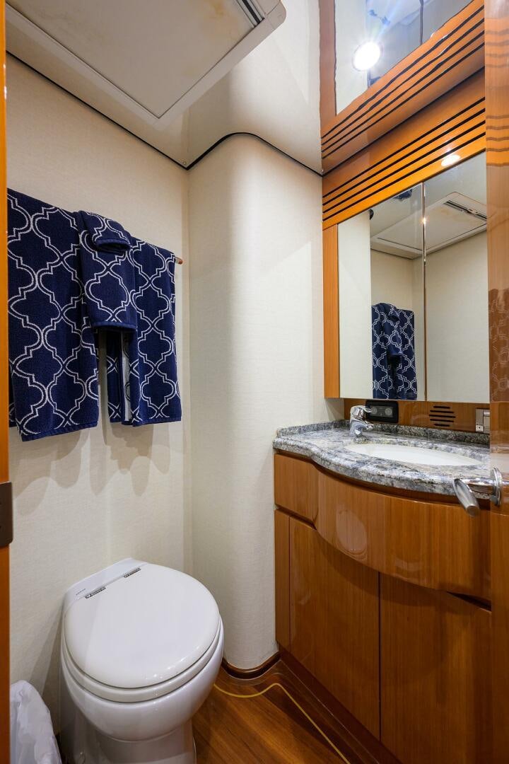 a bathroom with a toilet and a sink aboard GOIN DEEP Yacht for Sale