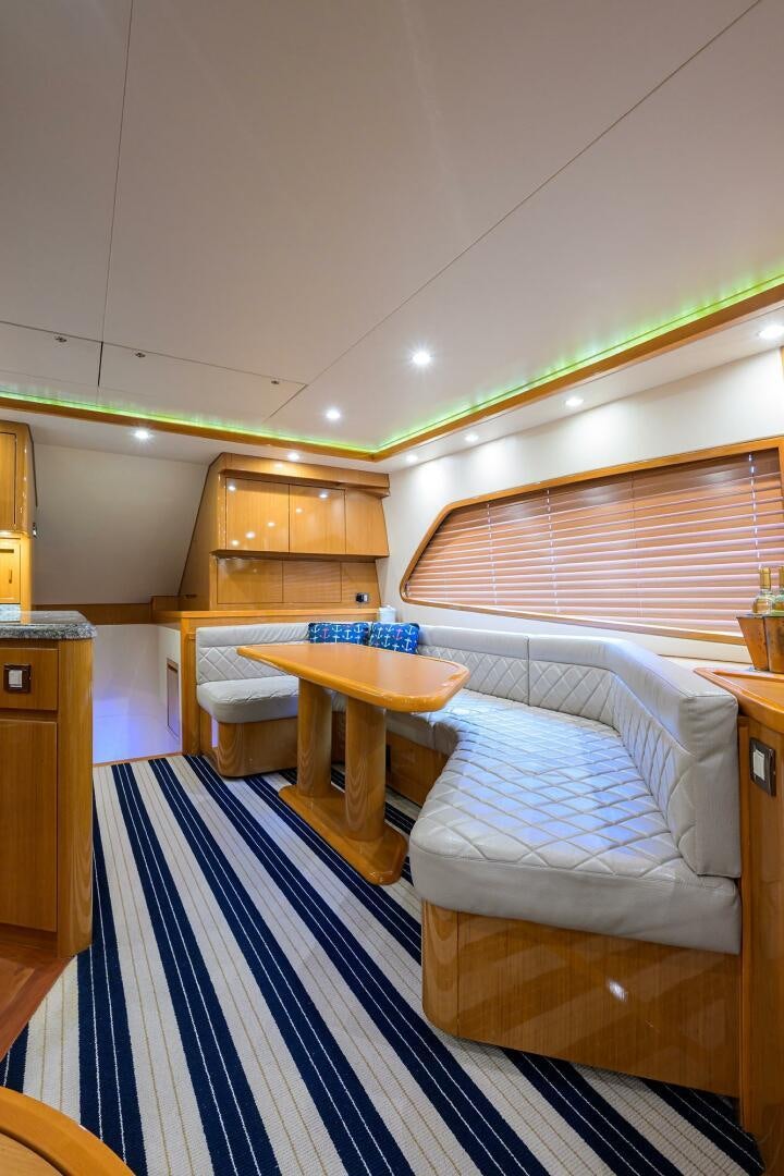 a room with a table and chairs aboard GOIN DEEP Yacht for Sale