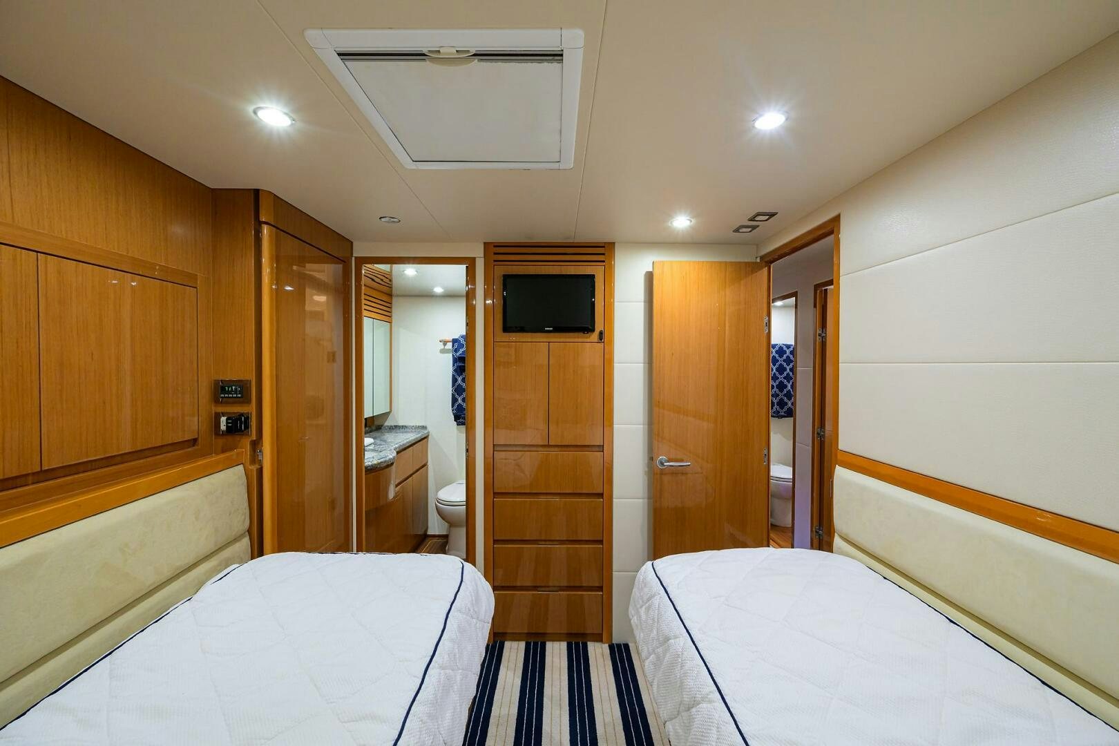 a room with a bed and a television aboard GOIN DEEP Yacht for Sale