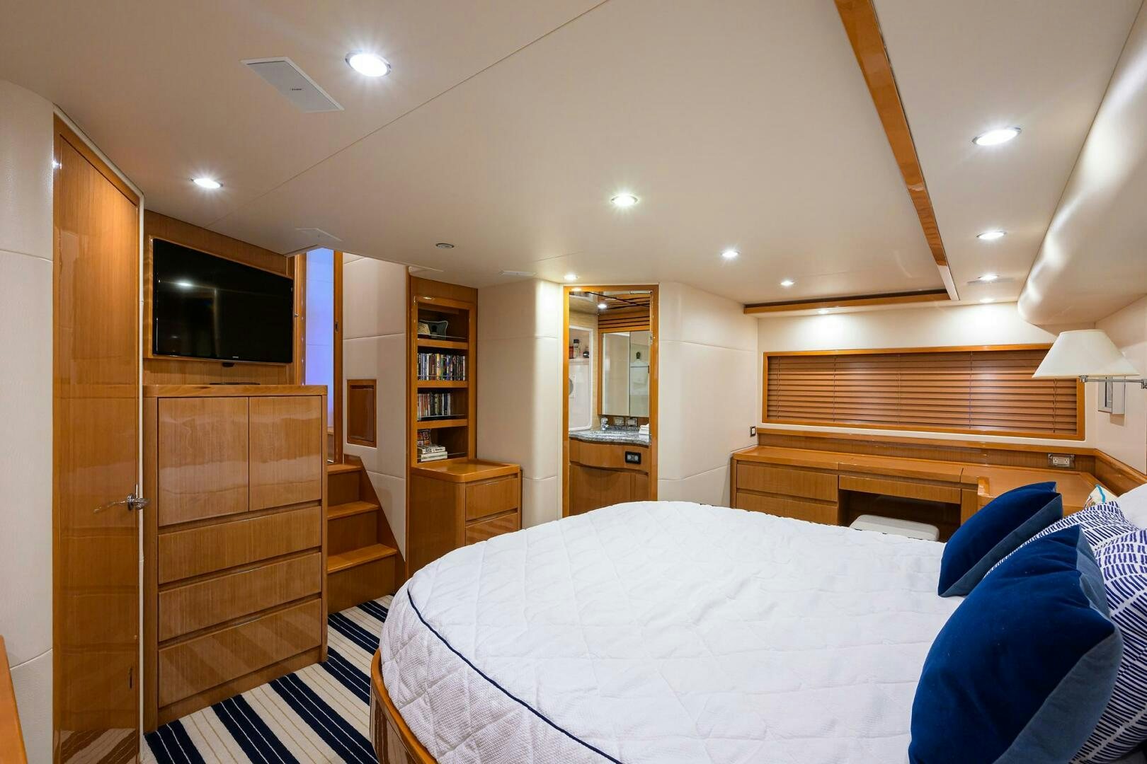 a bedroom with a bed and a closet aboard GOIN DEEP Yacht for Sale