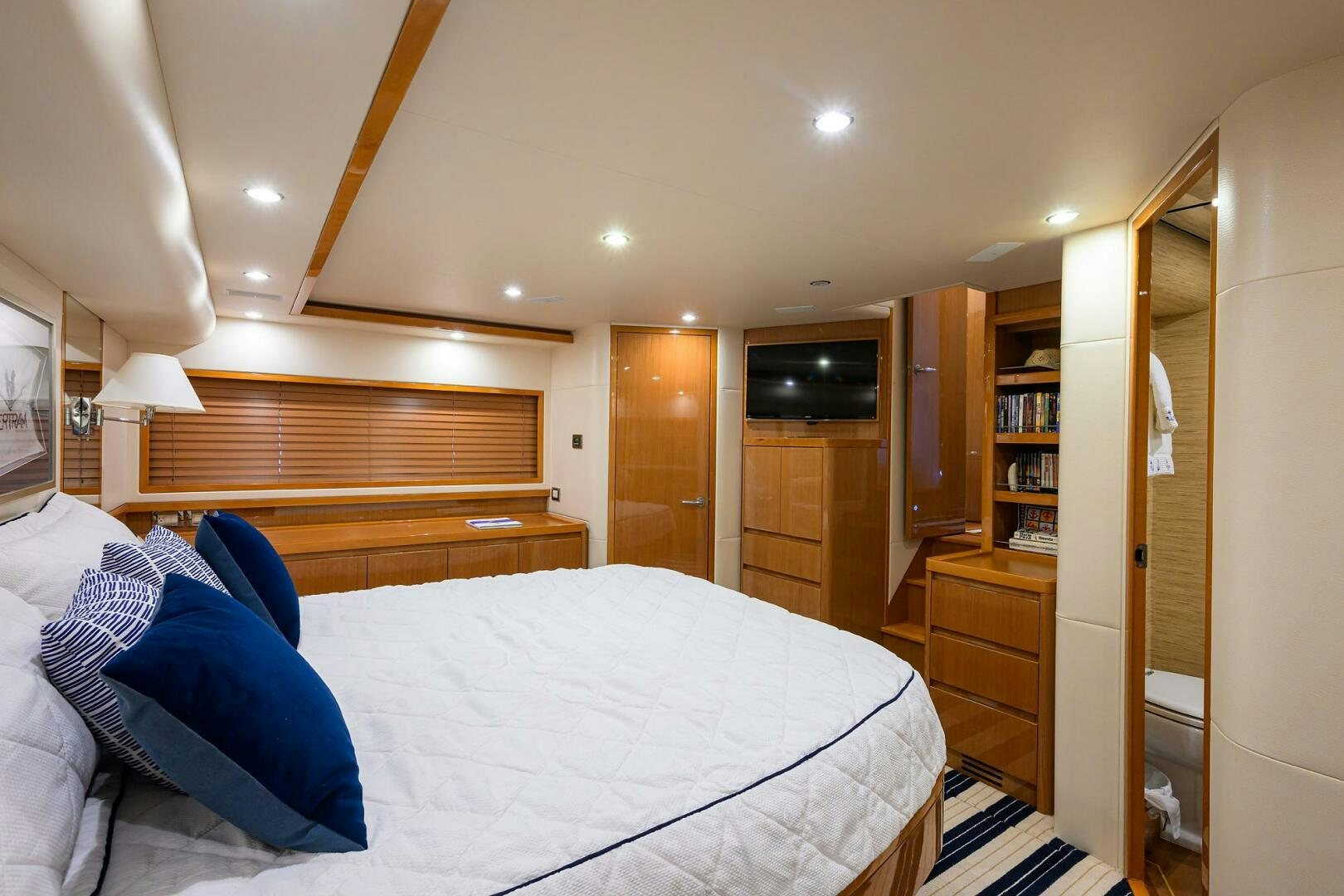 a bedroom with a bed and a closet aboard GOIN DEEP Yacht for Sale