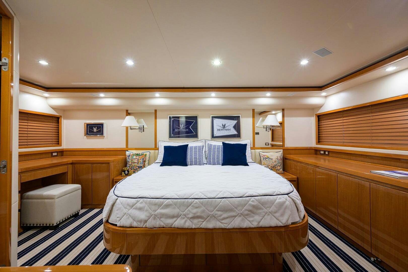 a bedroom with a bed and a desk aboard GOIN DEEP Yacht for Sale