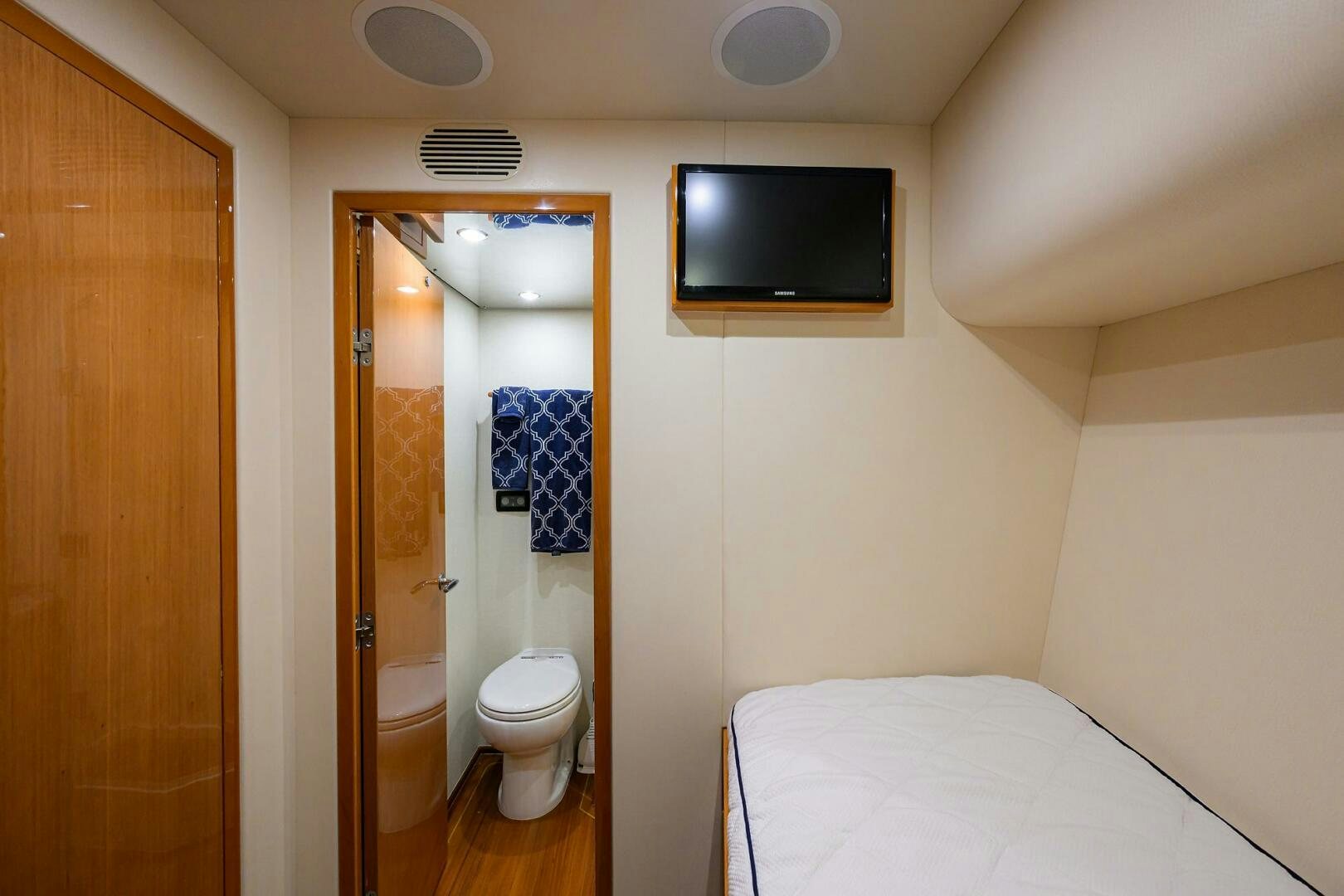 a bathroom with a television on the wall aboard GOIN DEEP Yacht for Sale