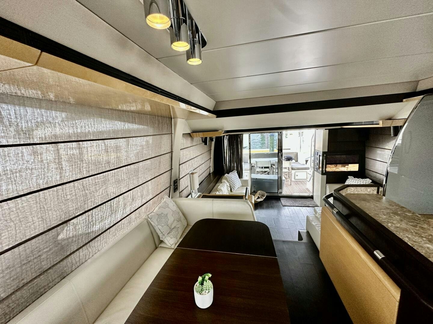a room with a table and couch aboard HOME WRECKER Yacht for Sale