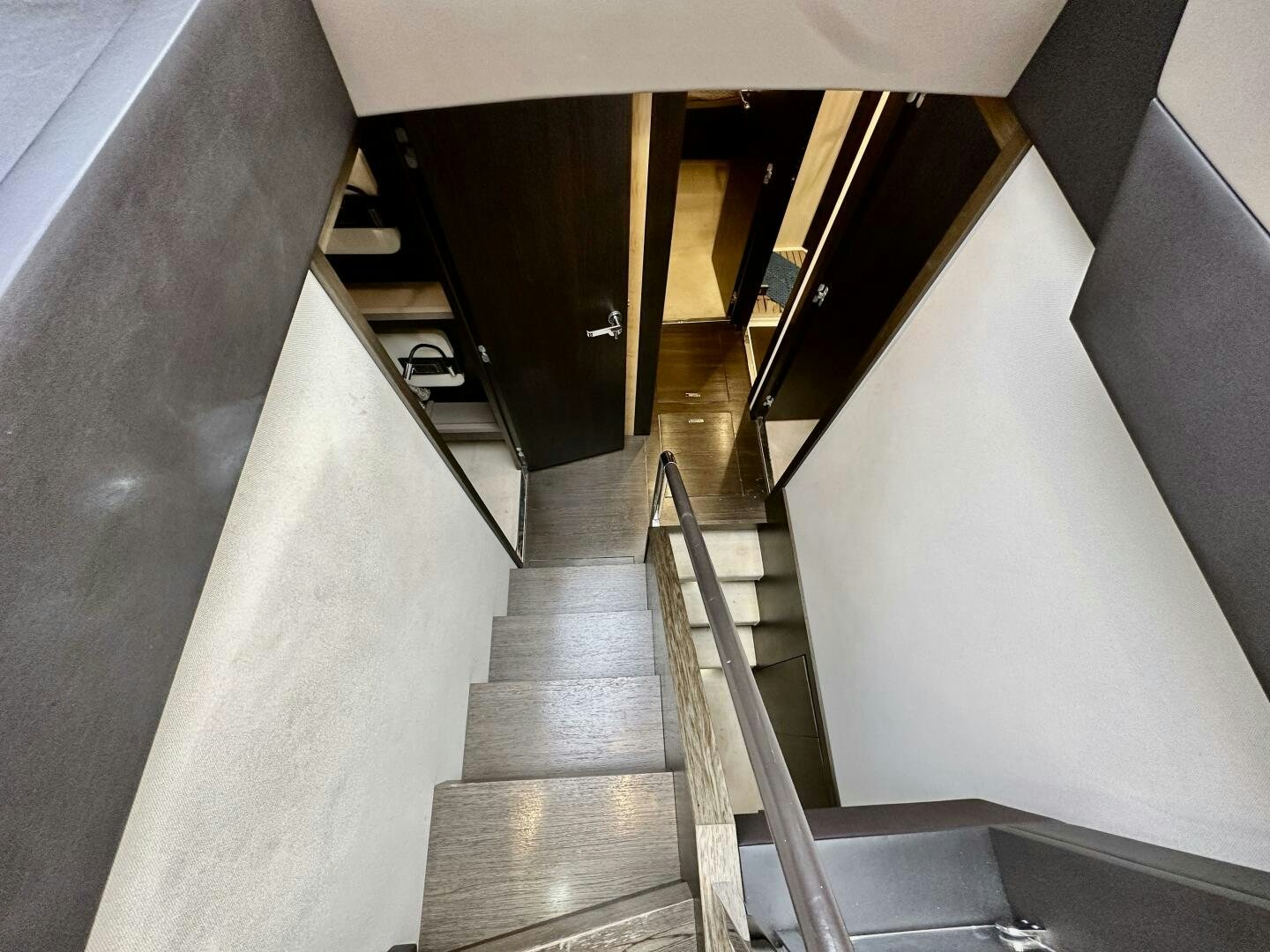 a staircase with a wood railing aboard HOME WRECKER Yacht for Sale