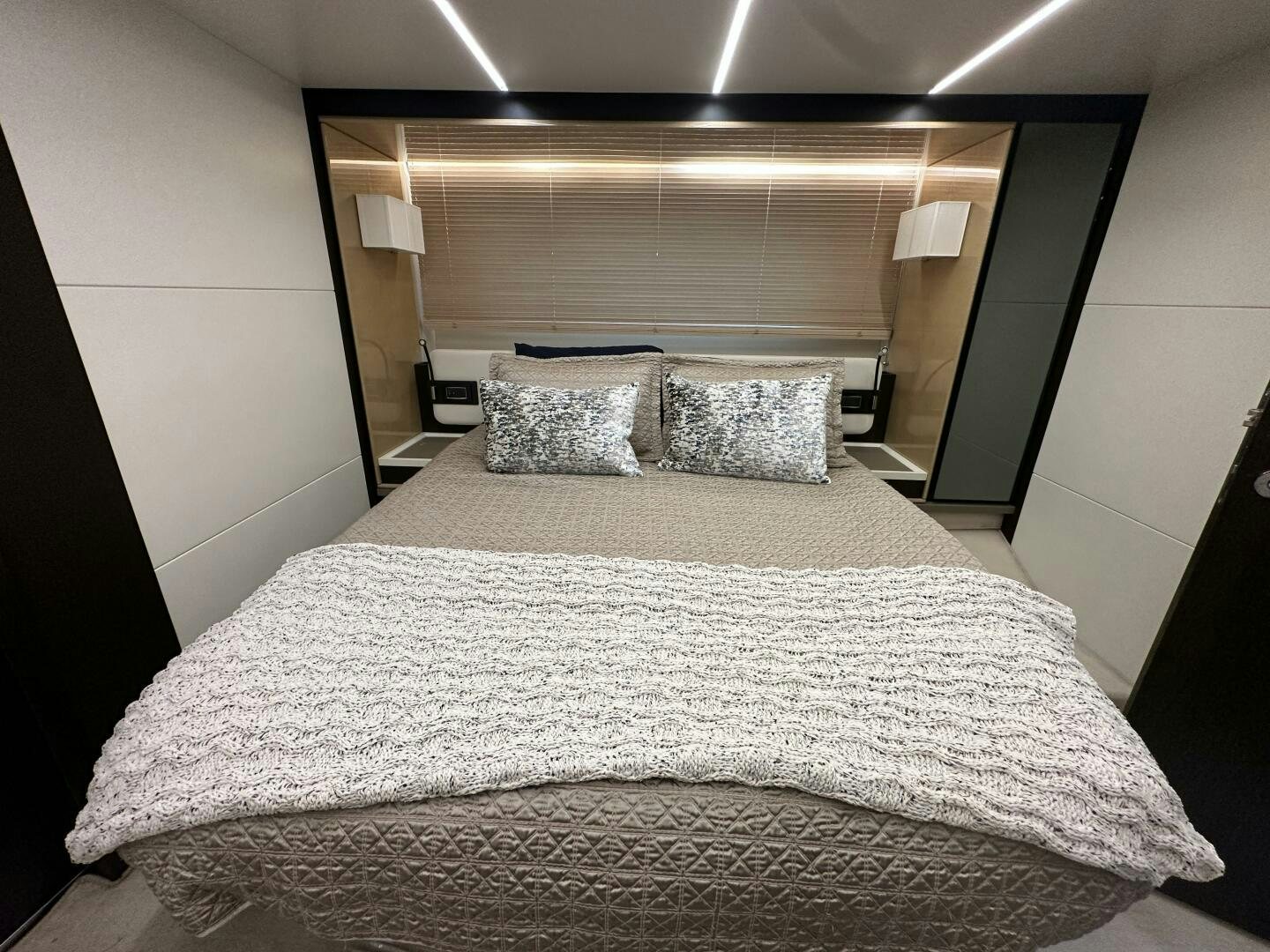 a bed with a white comforter aboard HOME WRECKER Yacht for Sale