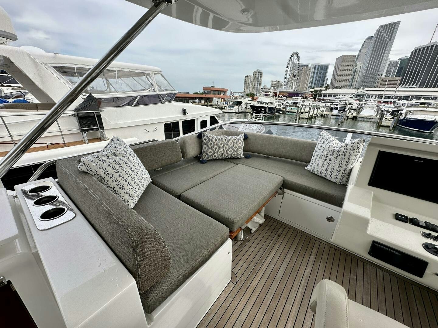 a deck with a view of a city and a large yacht aboard HOME WRECKER Yacht for Sale