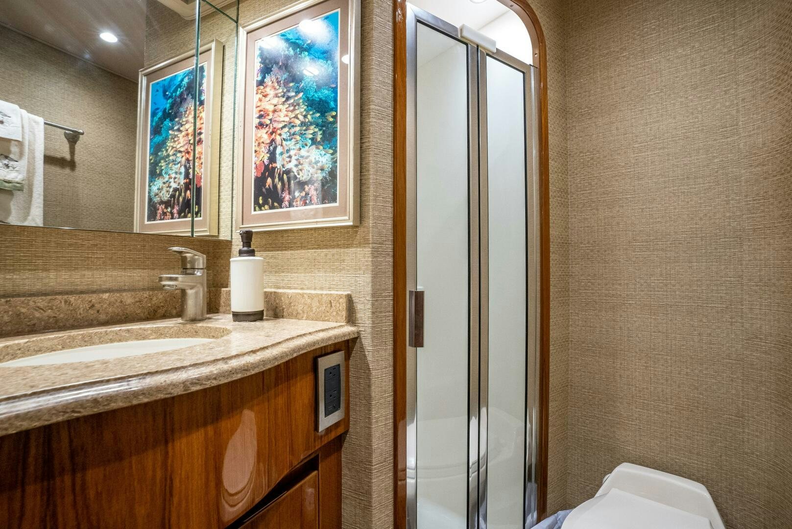 a bathroom with a glass shower aboard NO COLLARS Yacht for Sale