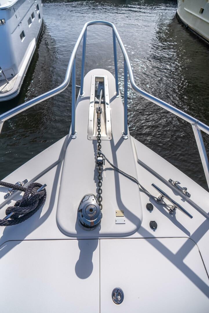 a white boat with a rope attached aboard NO COLLARS Yacht for Sale