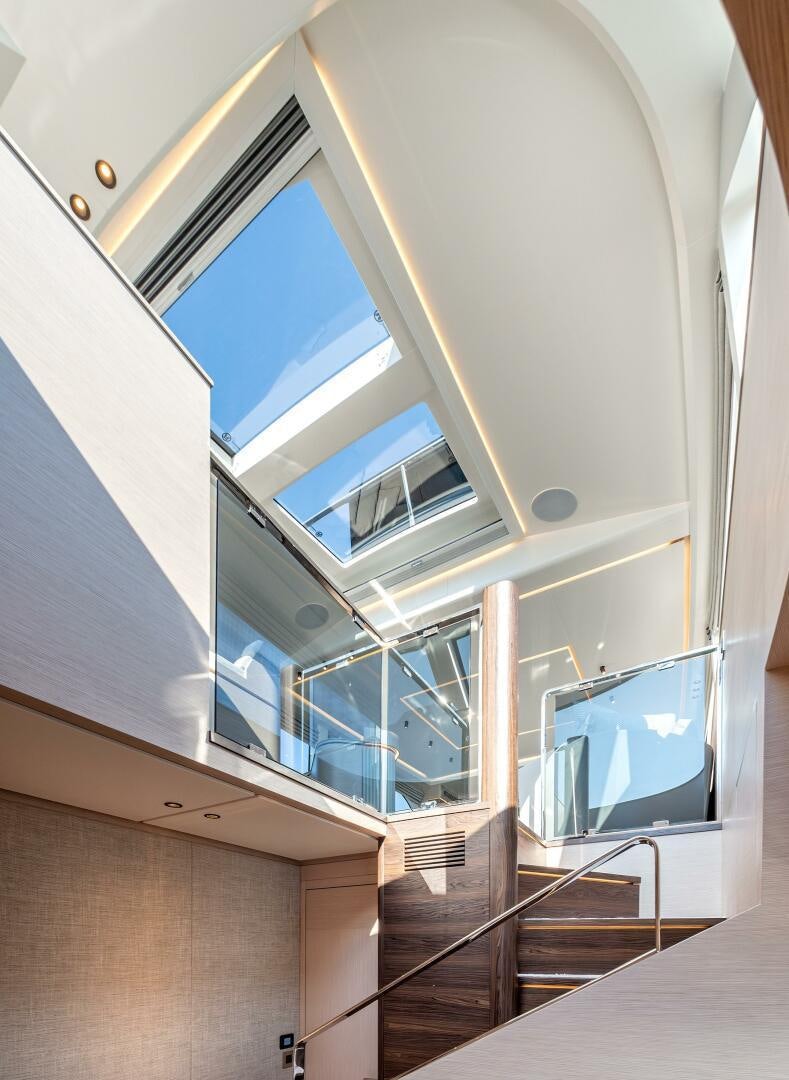 a room with a tv and a staircase aboard SUNYA Yacht for Sale