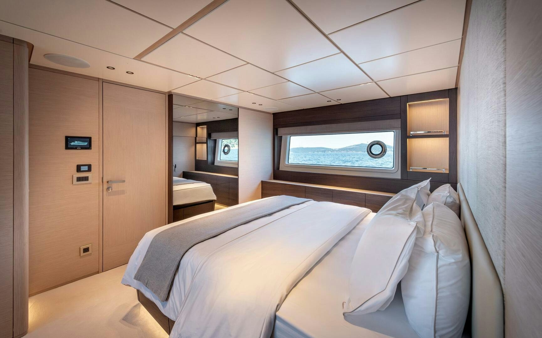 a room with a bed and a window aboard SUNYA Yacht for Sale