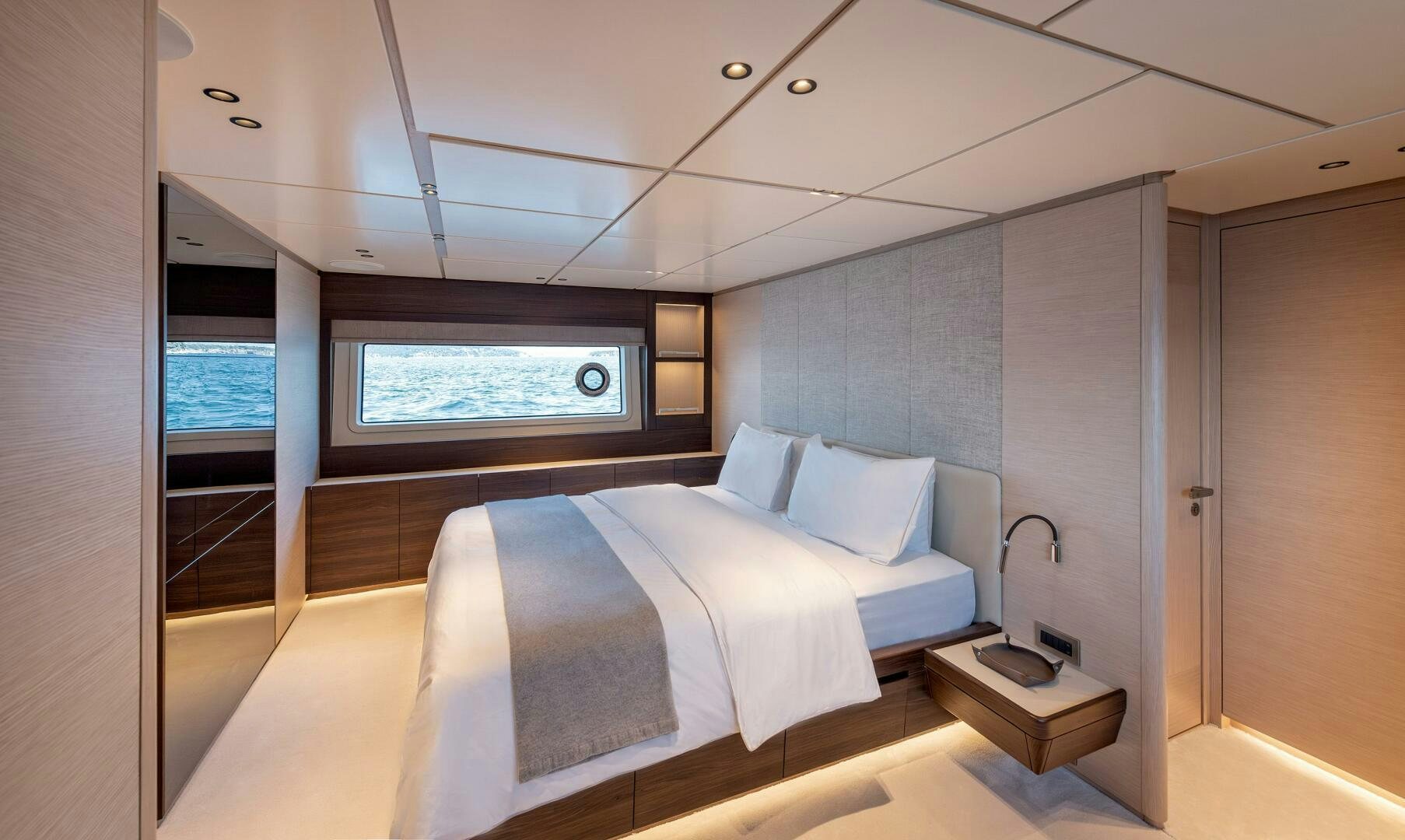 a room with a bed and a window aboard SUNYA Yacht for Sale