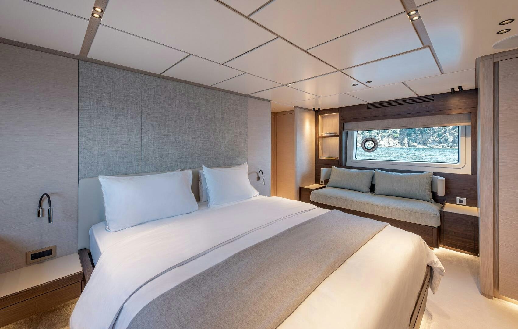 a room with a bed and a couch aboard SUNYA Yacht for Sale