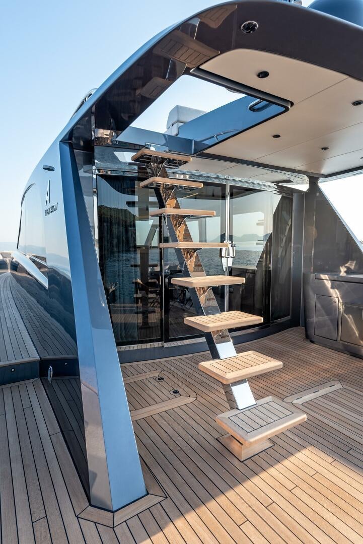 a large glass building with a staircase aboard SUNYA Yacht for Sale