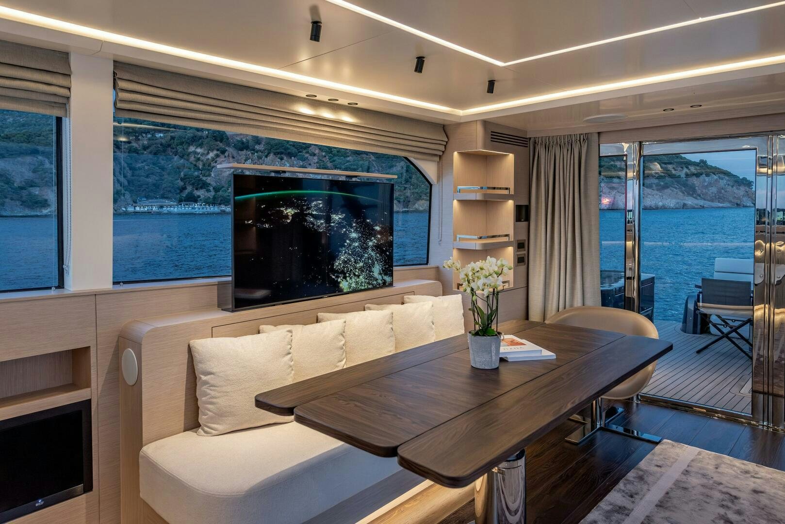 a living room with a large screen aboard SUNYA Yacht for Sale