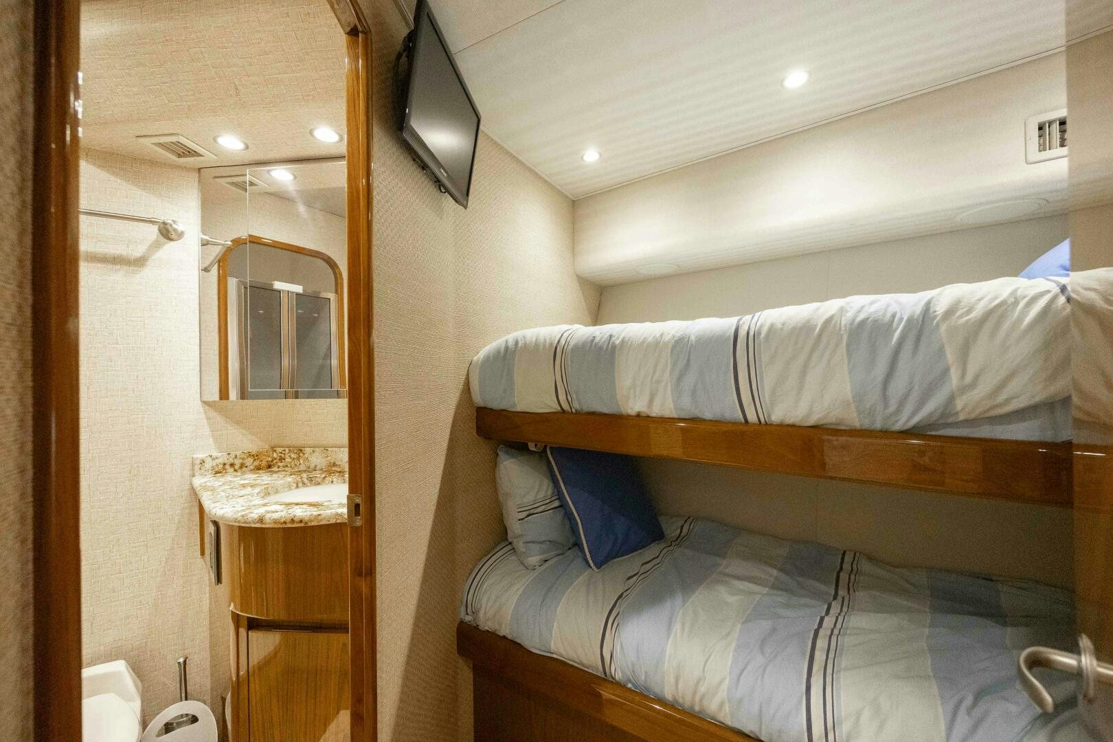 a room with a bed and a mirror aboard SAVING GRACE Yacht for Sale