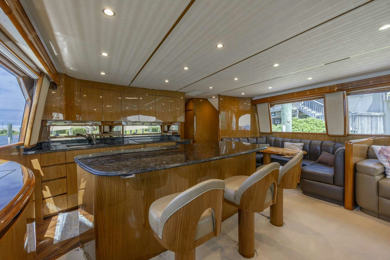 a large kitchen with a bar and a table aboard SAVING GRACE Yacht for Sale