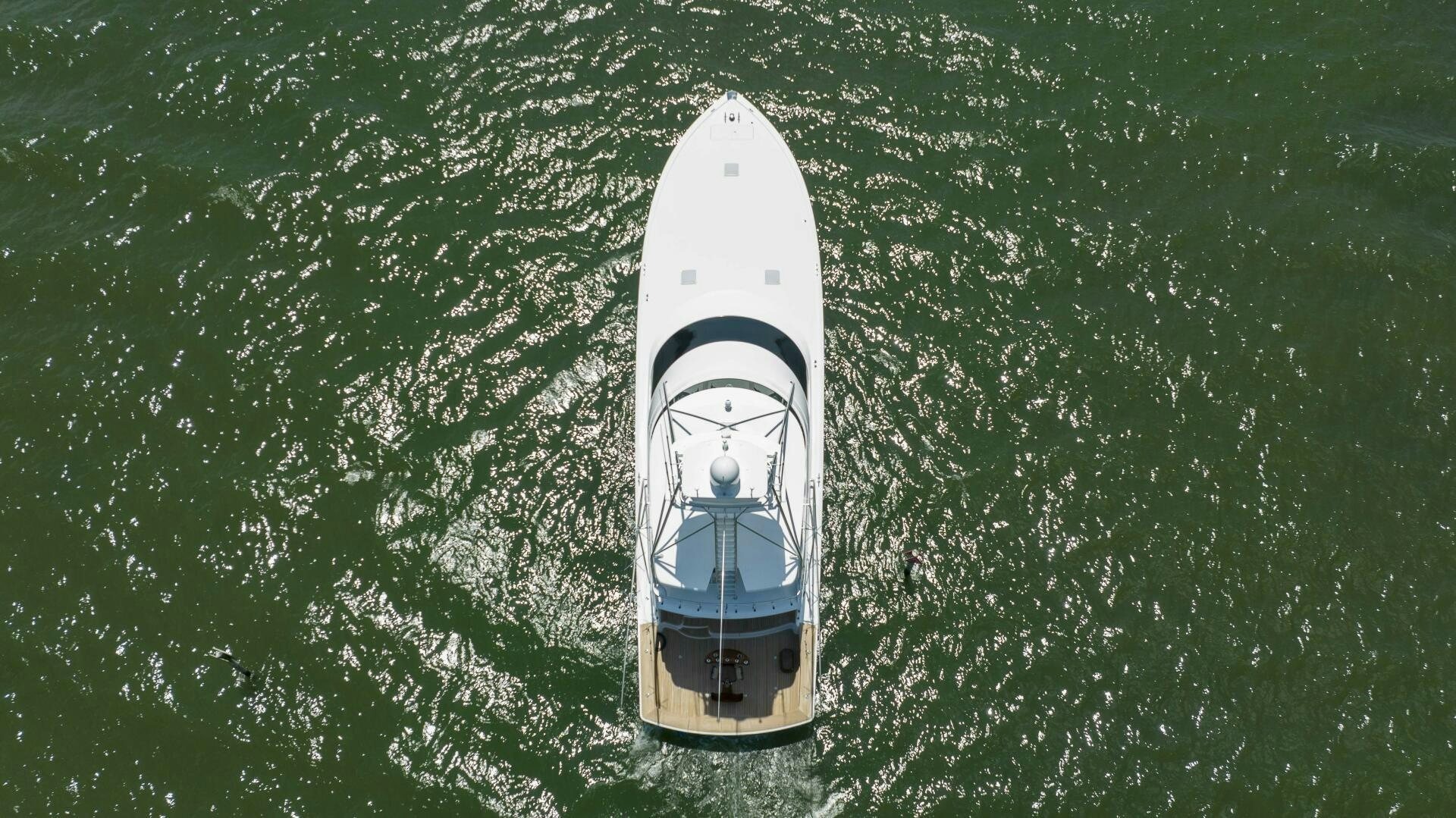 a white boat in the water aboard SAVING GRACE Yacht for Sale