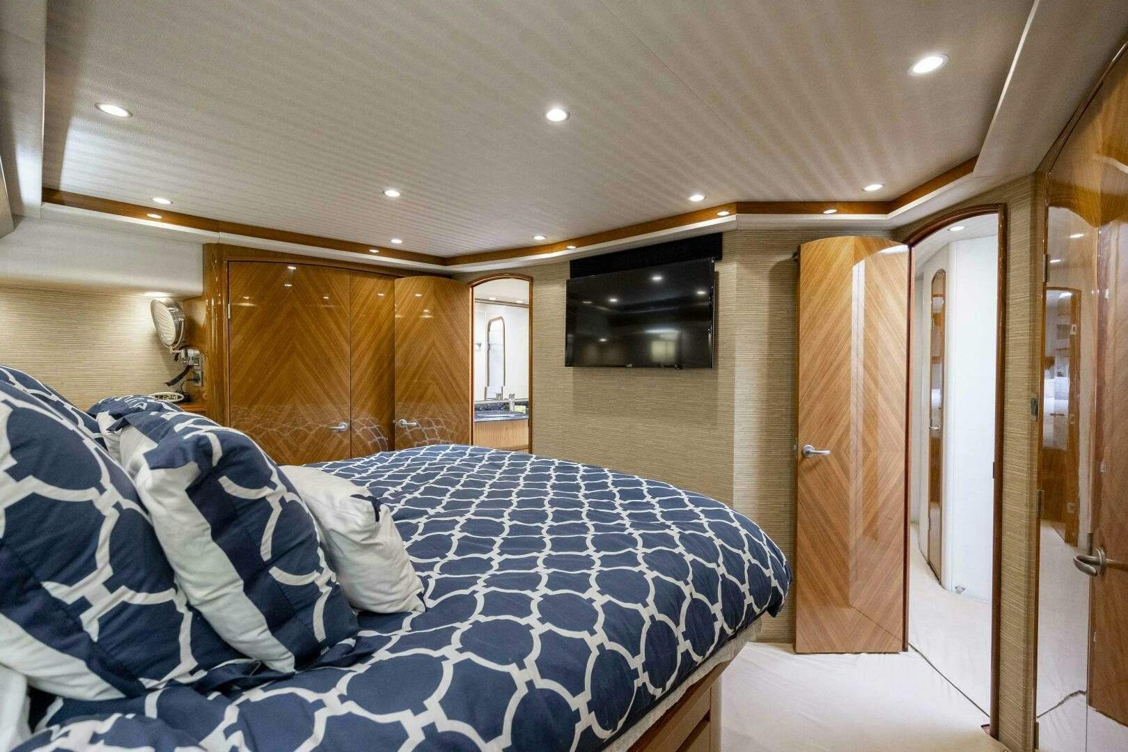 a bedroom with a bed and a television aboard SAVING GRACE Yacht for Sale