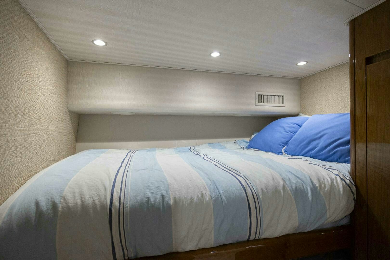 a bed with blue sheets aboard SAVING GRACE Yacht for Sale