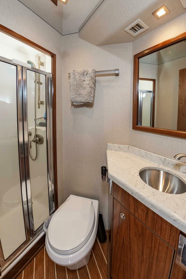a bathroom with a glass shower door aboard KNOT DONE YET Yacht for Sale