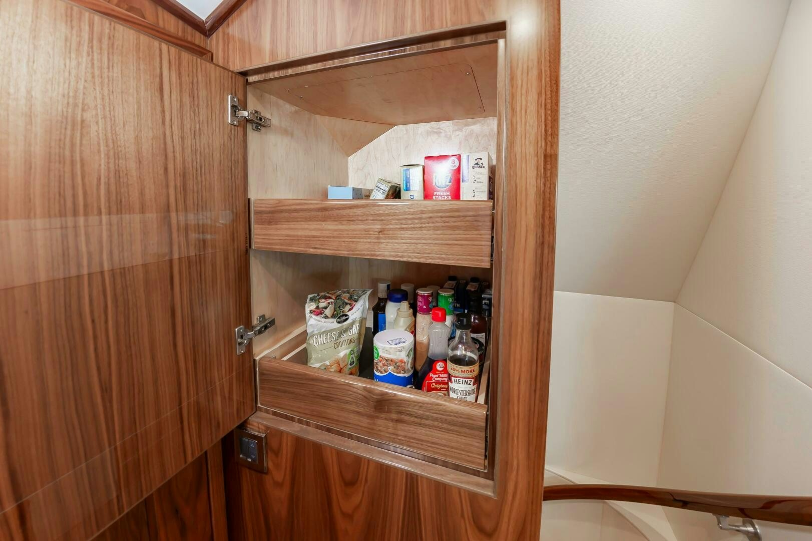 a wooden cabinet with a shelf of food and drinks aboard KNOT DONE YET Yacht for Sale