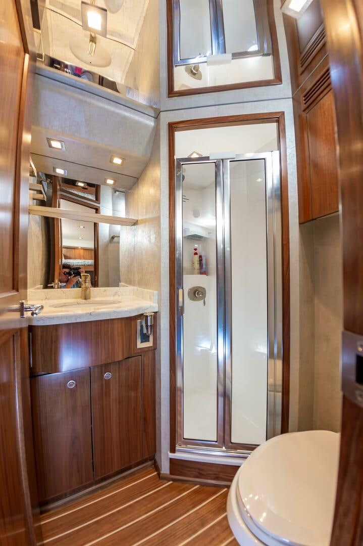 a bathroom with a glass shower aboard KNOT DONE YET Yacht for Sale