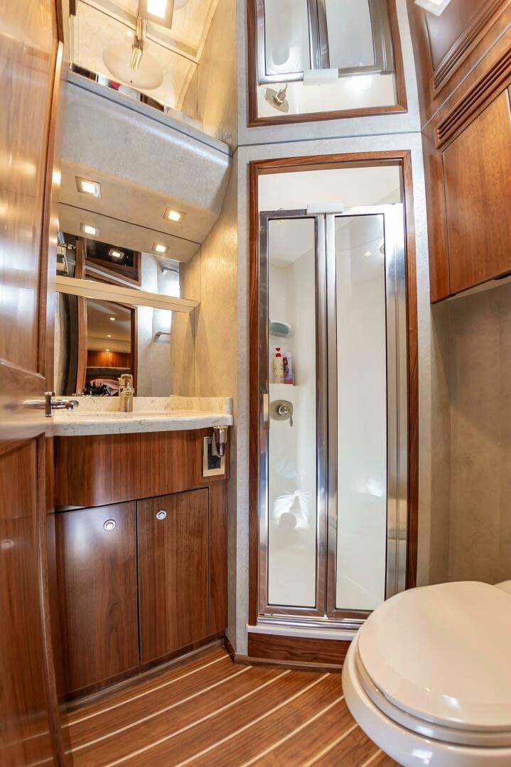 a bathroom with a glass shower aboard KNOT DONE YET Yacht for Sale