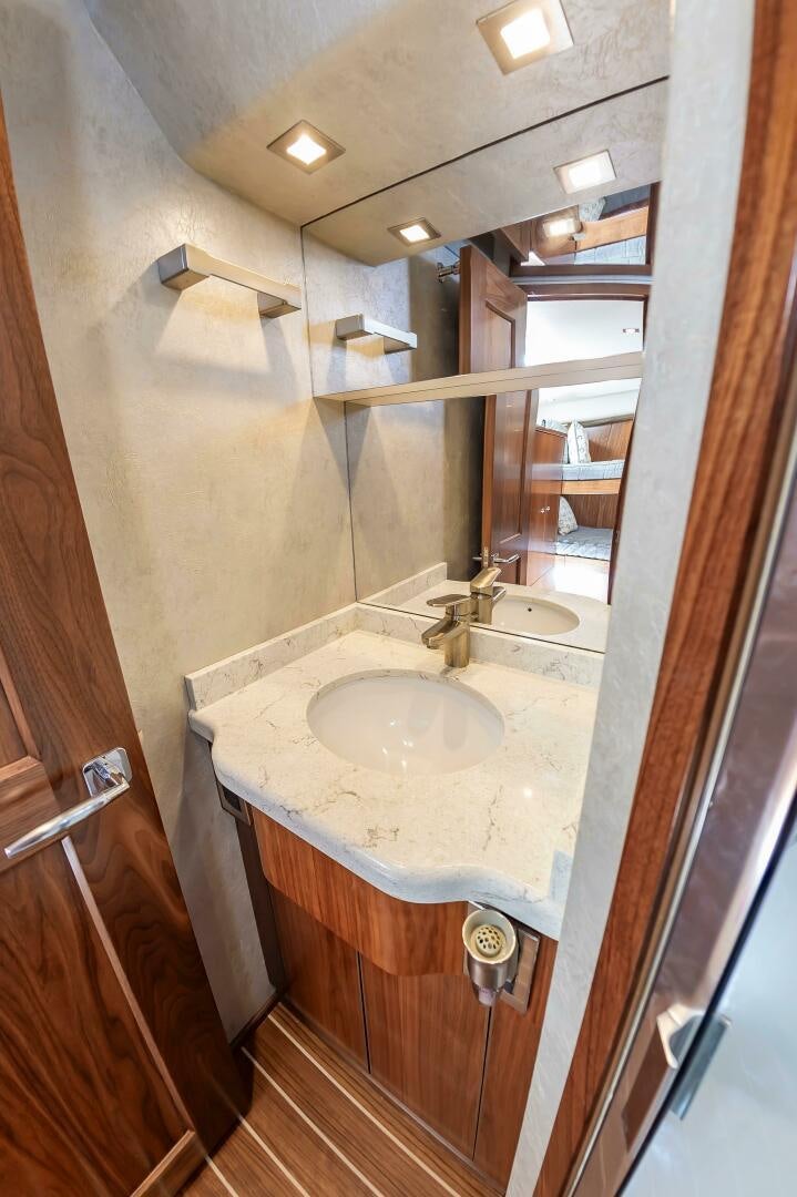 a bathroom with a sink and mirror aboard KNOT DONE YET Yacht for Sale