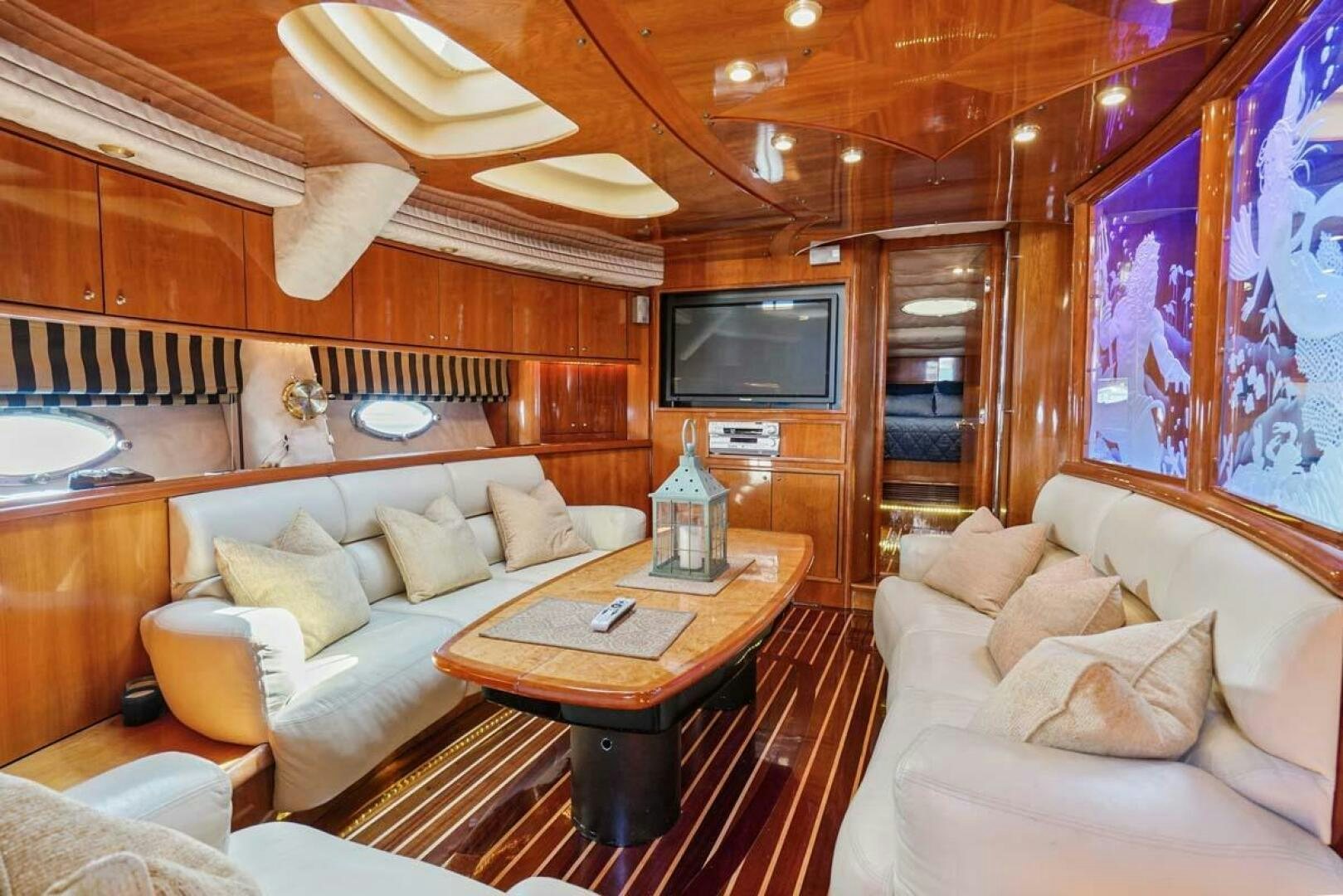 a living room with a couch and a television aboard OBSESSION Yacht for Sale