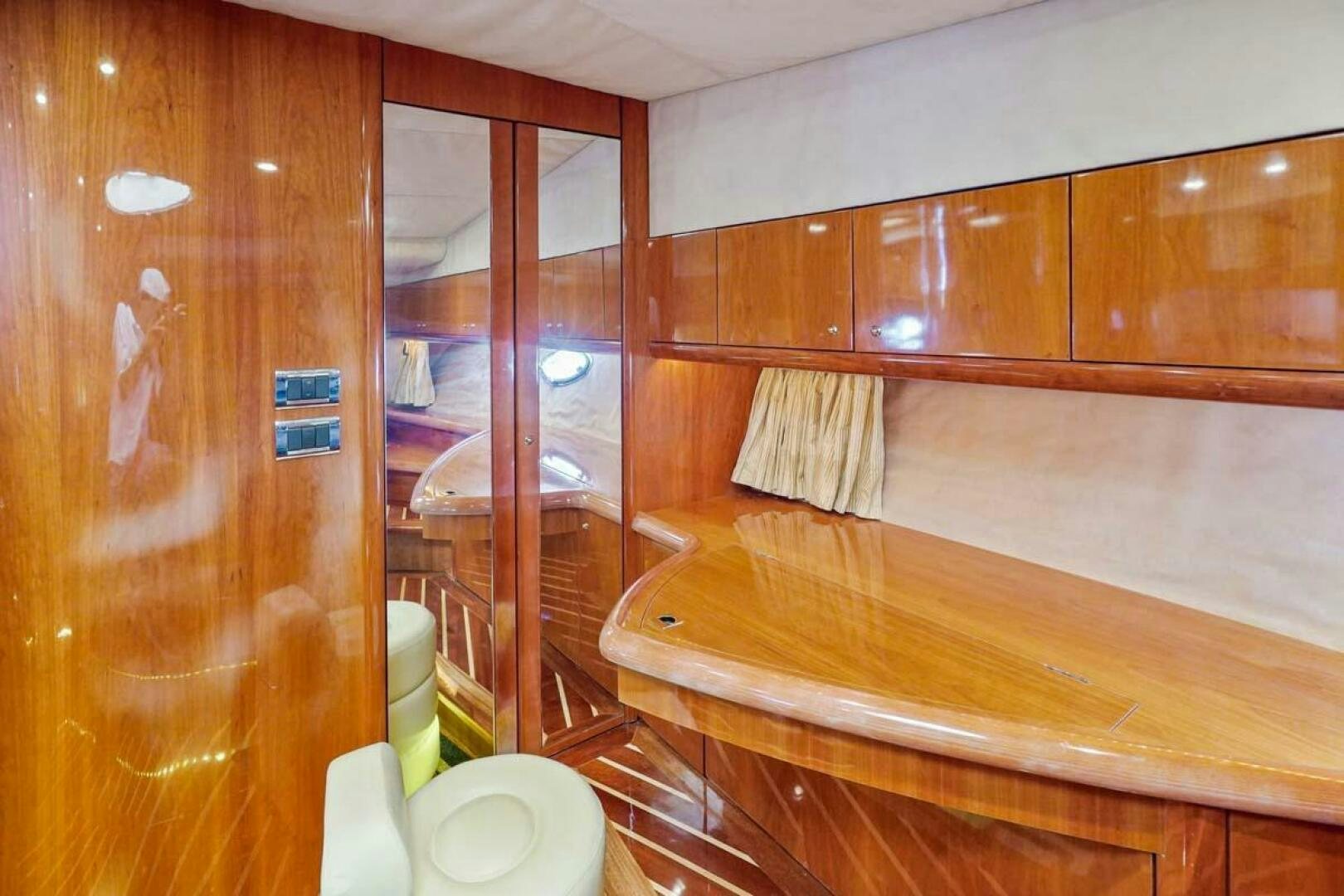 a room with wooden cabinets aboard OBSESSION Yacht for Sale