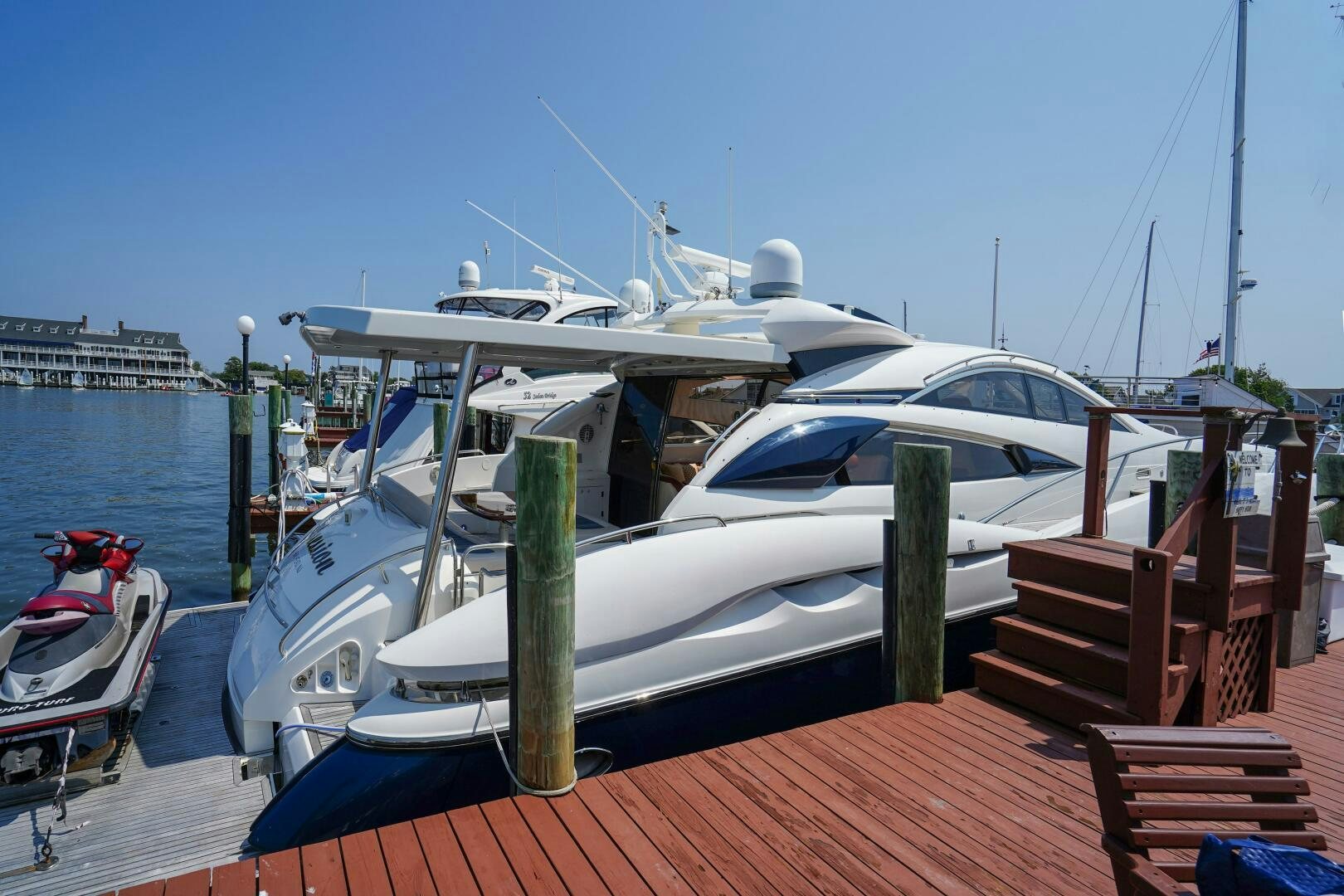 a boat docked at a pier aboard OBSESSION Yacht for Sale