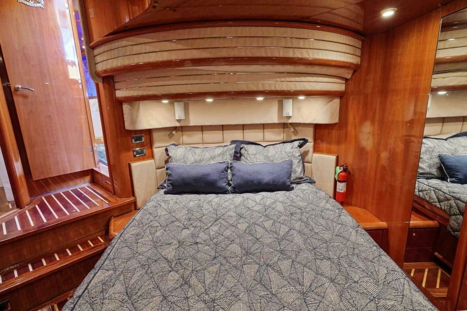 a bed with a wood canopy aboard OBSESSION Yacht for Sale