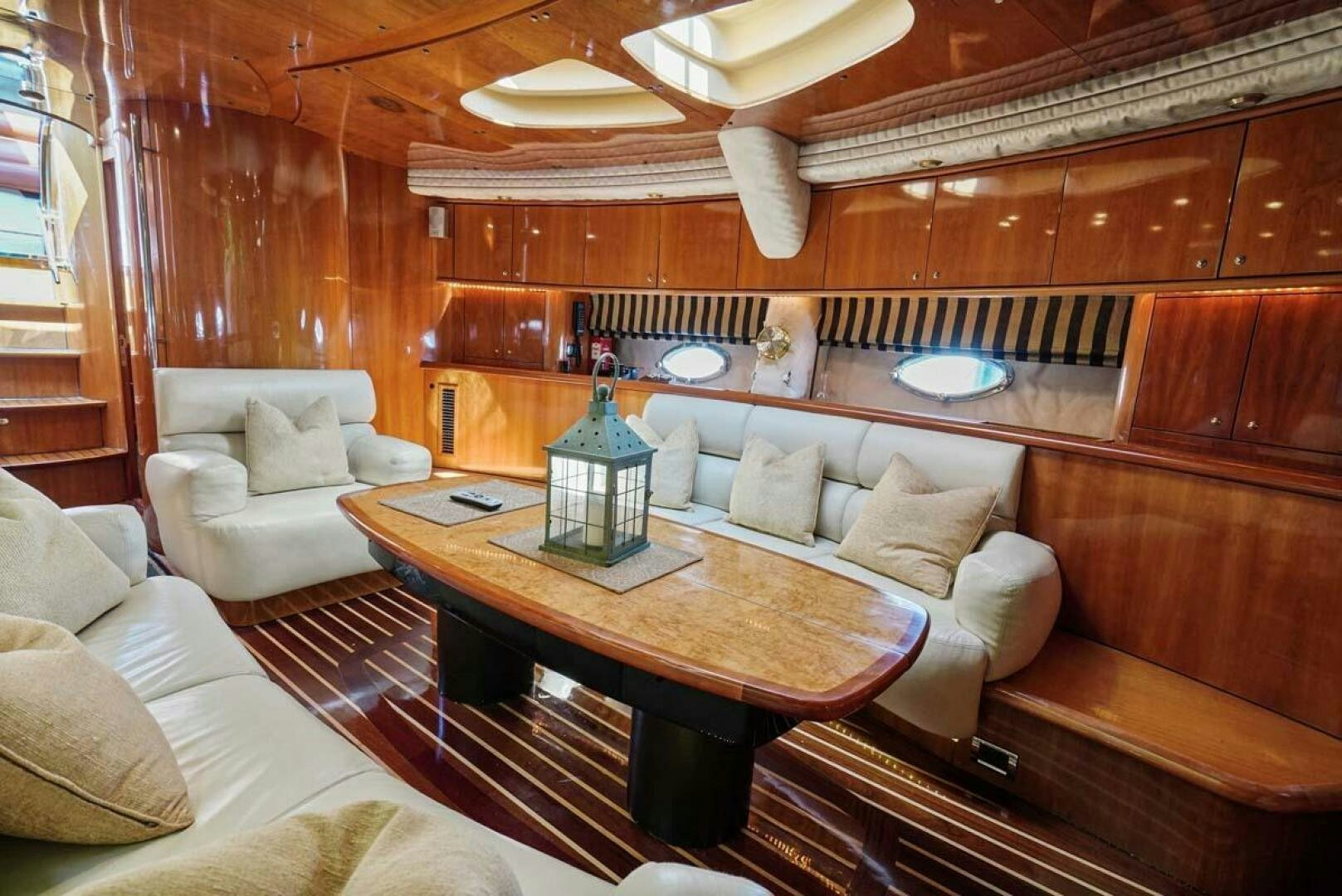 a room with a table and couches aboard OBSESSION Yacht for Sale