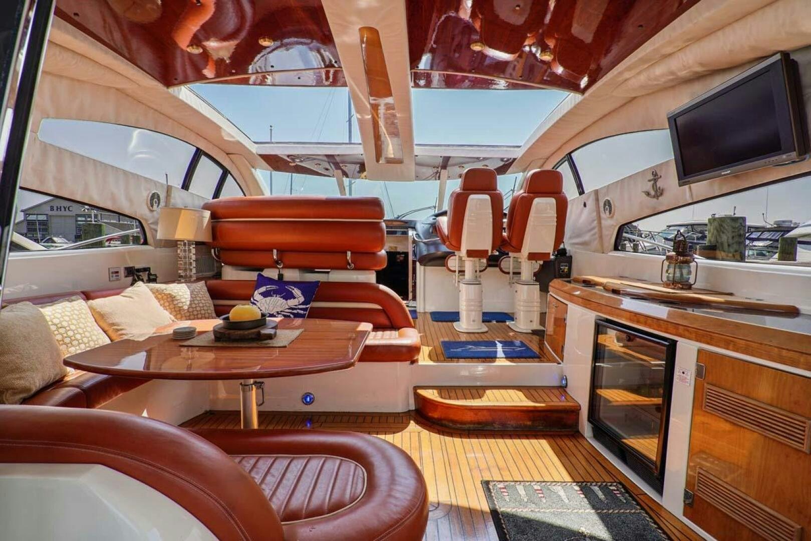 a living room with a kitchen and dining area aboard OBSESSION Yacht for Sale